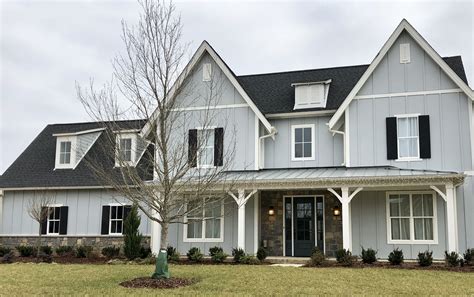 black metal roof grey house|grey house with black awnings.